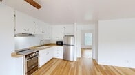 Located at 95 Winding Way in Napa, California, this one-bedroom, one-bathroom unit is thoughtfully laid out to maximize its compact footprint. Light-toned hardwood flooring runs consistently throughout the living areas, lending warmth and visual continuity to the space.

The open kitchen and living area form the heart of the unit. The kitchen features white shaker-style cabinetry extending to the ceiling for ample storage, warm wood-toned countertops, a stainless steel refrigerator, a stainless range, and a built-in microwave. A ceiling fan overhead aids circulation in the combined living space.

The bedroom offers a mirrored sliding-door closet, recessed wall lighting, and a large window fitted with vertical blinds that allow natural light while maintaining privacy. A second sizable window in the bedroom provides outdoor views of the surrounding landscaped greenery.

The bathroom is finished with large-format marble-look tile flooring, a wide vanity with a quartz countertop and ample cabinet storage, a lighted mirror, and a tub-shower combination with marble-tile surround.

A private balcony overlooks a well-maintained courtyard with mature trees, offering pleasant outdoor views within the established Napa complex.