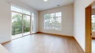 This well-appointed 2-bedroom, 2-bathroom residence on Old Sauk Road in Madison, Wisconsin offers a thoughtfully designed single-floor layout with a clean, modern aesthetic throughout. Light wood-tone flooring flows seamlessly across the living areas, bedrooms, and kitchen, creating a warm and cohesive atmosphere.

The kitchen serves as a central highlight, featuring light maple cabinetry, white subway tile backsplash, white quartz countertops, stainless steel appliances, and a spacious island with an integrated sink illuminated by striking black pendant lights. Open shelving adds both functionality and visual interest.

The living area is generously sized and filled with natural light from large windows and a sliding glass door that opens to a private balcony overlooking lush, mature trees — bringing a sense of the outdoors in.

The primary bedroom is comfortably sized, with a ceiling fan and a large window framing tranquil wooded views. The second bedroom is equally bright, featuring its own sizable window with outdoor greenery visible beyond. Each room includes dedicated closet space.

The two bathrooms are clean and functional — one featuring a full soaking tub and shower combo, and the other a walk-in shower with built-in shelving and grab bar. The overall design balances modern finishes with practical livability.