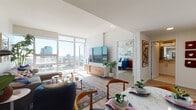 Located in the heart of downtown San Diego, this high-rise residence offers a thoughtfully designed single-floor layout with contemporary finishes throughout. Expansive floor-to-ceiling windows flood the living and dining areas with natural light while framing sweeping panoramic views of the San Diego skyline and beyond. The open-concept living space features light wood flooring, a seamless flow between the living and dining zones, and direct access to a balcony — ideal for enjoying the Southern California scenery. The kitchen is outfitted with sleek white cabinetry, a grey subway tile backsplash, stainless steel appliances including a range, microwave, and dishwasher, and ample counter space for everyday functionality. The bedroom is a bright, airy retreat with large floor-to-ceiling windows offering city views, and features a built-in closet for storage. A second flexible room with oversized windows and a closet can serve as a bedroom, office, or sitting area. Two full bathrooms complete the layout — one featuring a marble-tiled tub/shower combo and white vanity, and a second with a white vanity, mirror, and tiled flooring. Throughout, the clean, modern aesthetic and abundant natural light create a bright, welcoming atmosphere.
