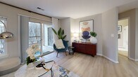 Located at 11555 Olde Tiverton Circle in Reston, VA, this well-appointed two-bedroom, two-bathroom residence offers a thoughtfully designed single-level floor plan. The open-concept living, dining, and kitchen area serves as the heart of the home, bathed in natural light from sliding glass doors that lead to a private outdoor patio. Light-toned hardwood-style flooring flows throughout the main living spaces, creating a bright and cohesive aesthetic.

The kitchen features warm wood cabinetry, dark granite countertops, stainless steel appliances, and a peninsula with bar seating — ideal for casual dining or entertaining. The adjacent dining area offers a seamless connection to the living room, which benefits from generous natural light and patio access.

The primary bedroom is a comfortable retreat with sliding glass doors opening to an outdoor space, plush carpeting, and a walk-in closet. The second bedroom also features carpeted flooring, a large window with natural views, and ample closet space. Both bathrooms are finished with tile flooring, wood vanities, and shower-tub combinations. Additional highlights include three closets for storage and a dedicated in-unit laundry room with a full-size washer and dryer.