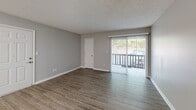 Located at 504 Bethel Rd in Morganton, NC, this single-floor, 2-bedroom, 2-bathroom residence offers a practical and well-organized layout. The kitchen is equipped with warm oak cabinetry, granite-look countertops, a double-basin stainless steel sink, and white appliances including an electric range and full-size refrigerator. It opens seamlessly into a dining area illuminated by a classic chandelier, creating an inviting flow. The living room is generously proportioned, featuring durable wood-look flooring, neutral gray walls, a textured ceiling, and a sliding glass door that fills the space with natural light and provides outdoor access. A hallway connects the main living areas to the two bedrooms, both of which feature the same wood-look flooring, neutral tones, textured ceilings, and windows with blinds that allow for natural light. The spacious primary bedroom offers ample room for furniture arrangements. The two bathrooms are finished with granite-look countertops, oak vanities, and light flooring; one includes a full tub-shower combination. Additional features include a dedicated utility room, a closet for storage, and consistent finishes throughout that give the home a clean, cohesive feel.