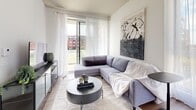 Located at 815 Avenue Plymouth in Mont-Royal, Quebec, this well-designed 2-bedroom, 2-bathroom residence offers a thoughtfully laid-out single-floor plan. A bright, elongated hallway with light wood flooring, recessed lighting, and clean white walls with panel-style doors creates an inviting entrance, complete with a dedicated closet for storage.

The open-concept living and dining area is a standout feature, bathed in natural light from large floor-to-ceiling windows with sheer curtains that frame outdoor views of the surrounding neighbourhood. Light hardwood flooring runs throughout, complementing the airy, neutral palette. A wall-mounted split system provides climate control, while the adjacent kitchen features white upper cabinetry, two-tone lower cabinets, a white subway tile backsplash, and a full suite of stainless steel appliances.

The primary bedroom is generously proportioned, boasting a large window that floods the room with daylight and views outdoors. The second bedroom is equally bright and well-appointed with wood flooring. Both bathrooms are finished with large-format marble-look floor tiles and clean white walls. The main bathroom includes a soaking tub with a glass sliding enclosure and elegant stone-tiled surround, while the second bathroom features a sleek vanity with a modern walk-in shower.