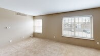 Located at 2195 E 14 Mile Rd in Sterling Heights, Michigan, this single-floor, one-bedroom, one-bathroom unit offers a practical and well-organized layout. The combined kitchen and living area serves as the heart of the home, where dark wood cabinetry lines the walls of the kitchen, providing ample storage space. The kitchen features hardwood-style flooring, a gas range, refrigerator, and a double sink set into a light-toned countertop, all illuminated by flush-mount ceiling lighting. The adjoining living area continues the warm, neutral palette with open wall space and the same flooring. The spacious bedroom is carpeted and bathed in natural light from multiple windows fitted with blinds, offering views to the outside. A ceiling fan with an integrated light fixture adds comfort and functionality. The bedroom also features a dedicated closet and direct access to the bathroom, enhancing convenience. The full bathroom is cleanly appointed with white square tile surrounding the tub and shower combo, complemented by tile flooring in earthy tones and a vanity with a white countertop. A hallway connects the spaces efficiently, and a dedicated entrance completes the layout. Neutral wall tones throughout create a cohesive, move-in-ready atmosphere.