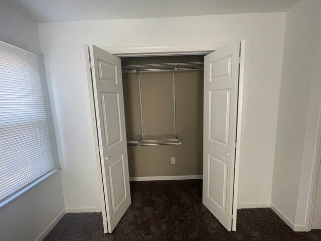 Main Bedroom Closet with Shelving Unit - 1139 Booker Dr
