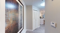 Located in Orlando, FL, this well-appointed 2-bedroom, 2-bathroom residence offers a thoughtfully designed single-floor layout that maximizes functionality and comfort. Light wood-style flooring flows throughout the main living areas, complemented by neutral wall tones that create a bright, cohesive atmosphere.

The open-concept kitchen is a standout feature, showcasing white cabinetry, dark granite countertops, stainless steel appliances, and a breakfast bar with stylish gold-framed barstools. Pendant lighting above the bar adds a modern touch. The kitchen connects seamlessly to the living room, which benefits from multiple windows dressed in sheer curtains, allowing ample natural light and outdoor views. A private exterior door in the living area provides additional access.

A carpeted hallway with mirrored closet doors leads to the two bedrooms, each offering plush carpet flooring and windows with exterior views. The primary bedroom is a comfortable retreat with dual windows overlooking greenery. Both bathrooms feature white vanity cabinetry, dark granite countertops, and well-lit vanity mirrors. A dedicated laundry area adds everyday convenience. The entry hallway sets an inviting tone with clean lines and louvered closet doors rounding out this functional Orlando residence.