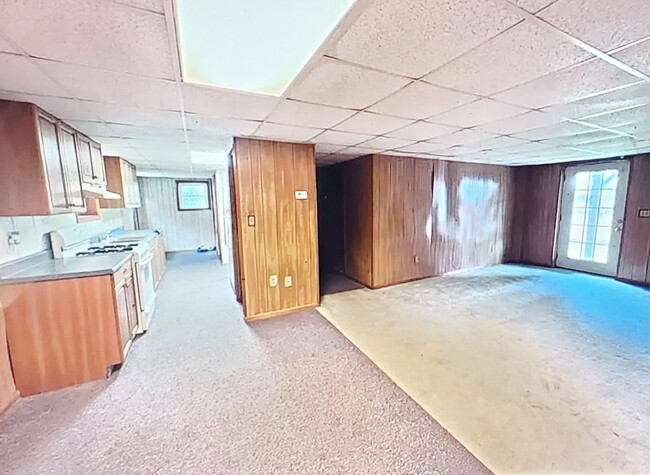 Kitchen, dinning room, living room view with backyard door. - 401 Maple St