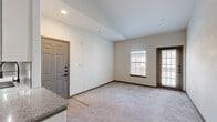 Located at 9111 Lakes at 610 Dr in Houston, TX, this 2-bedroom, 1-bathroom unit is housed within a classic brick exterior building with an arched entryway and mature landscaping. The single-floor layout offers a comfortable and efficient use of space throughout.

The living area welcomes you with neutral-toned carpet, soft natural light from dual windows, and a private entry door — creating a warm and open atmosphere. Adjacent to the living space, the kitchen is a standout feature, showcasing granite countertops, white shaker-style cabinetry, a subway tile backsplash, stainless steel appliances including a refrigerator, range, and microwave, as well as track lighting and durable wood-look flooring.

The primary bedroom is generously sized, featuring plush carpet, a ceiling fan, a natural light source from a window, and access to a walk-in closet with built-in shelving. The second bedroom is cozy and bright, also carpeted with a large window. Both rooms are finished with dark wood-trimmed doors and baseboards that add a cohesive, polished look throughout.

The full bathroom includes a tiled tub-shower combination with clean white tile surround and wood-look flooring. Additional conveniences include a dedicated laundry area and a closet for extra storage.