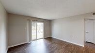 Located at 416 Hay Dr SW in Decatur, Alabama, this efficiently designed one-bedroom, two-bathroom single-floor residence offers a cohesive and modern interior throughout. Warm wood-look flooring flows consistently across the living spaces, complemented by neutral gray-toned walls and clean white trim that create a bright, welcoming atmosphere.

The living room is a comfortable, open space highlighted by sliding glass doors that invite natural light and provide direct views of the outdoors. Adjacent to the living area, the dining space connects seamlessly to the galley-style kitchen, which features white shaker cabinetry, light stone-look countertops, a stainless steel sink, and a full suite of stainless steel appliances including a refrigerator, range, and dishwasher.

The bedroom offers a well-proportioned layout with a window fitted with blinds that allow ample natural light, along with access to a spacious walk-in closet equipped with wire shelving for organized storage. This closet connects directly to one of the two bathrooms, which includes a white vanity, mirror with overhead lighting, and a tub-shower combination with grab bars. The second bathroom similarly features clean, updated finishes. A hallway ties all rooms together, contributing to the unit's efficient and functional floor plan.