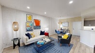 Located at 700 Forest Park Boulevard in Oxnard, California, this thoughtfully designed one-bedroom, one-bathroom residence offers a comfortable and efficiently organized single-floor layout. The living room serves as the heart of the home, featuring light wood-look flooring, recessed lighting, a whitewashed brick accent wall, and large windows that allow natural light to pour in. A welcoming entry area provides immediate access to the open-concept living space. Adjacent to the living room, the dining area showcases a bold geometric-patterned wallpaper accent wall, a sculptural wooden pendant light, and a bright white round dining table flanked by cobalt blue chairs, creating a striking visual contrast. The galley-style kitchen is equipped with dark espresso cabinetry, white quartz countertops, stainless steel appliances, under-cabinet lighting, and durable wood-look flooring. The bedroom features a bold navy and red striped accent wall, plush carpet, dual closets, and multiple windows overlooking the outdoors, filling the room with natural light. The bathroom is appointed with a dual-sink vanity, warm wood cabinetry, and a large wall mirror, offering both functionality and comfort. Throughout the residence, cohesive modern design elements and vibrant accents create an energetic yet welcoming ambiance.