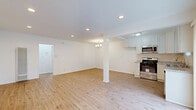 Located at 7550 Fountain Ave in the heart of West Hollywood, this well-appointed one-bedroom, one-bathroom unit offers a thoughtfully designed layout across a single floor. Light-toned hardwood flooring flows throughout, creating a cohesive and airy feel across the entire space.

The open-concept living and kitchen area serves as the heart of the unit. The living room is generously proportioned, featuring recessed lighting, a chandelier accent, and a structural column that adds architectural character. A large wall-mounted HVAC unit provides climate control. The kitchen is equipped with white shaker-style cabinetry, granite-look countertops, and a full suite of stainless steel appliances including a gas range, over-the-range microwave, and dishwasher. A window above the sink brings in natural light, and vertical blinds along a sliding door offer outdoor access and additional brightness.

The bedroom is a comfortable size, featuring a large sliding-door closet, a window with vertical blinds admitting natural light, and a wall-mounted air conditioning unit. A hallway connects the main living areas and provides access to two closets for additional storage.

The bathroom is finished in crisp white tile, featuring a combined tub and shower, a vanity with ample counter space, and a frosted window for natural light and privacy.