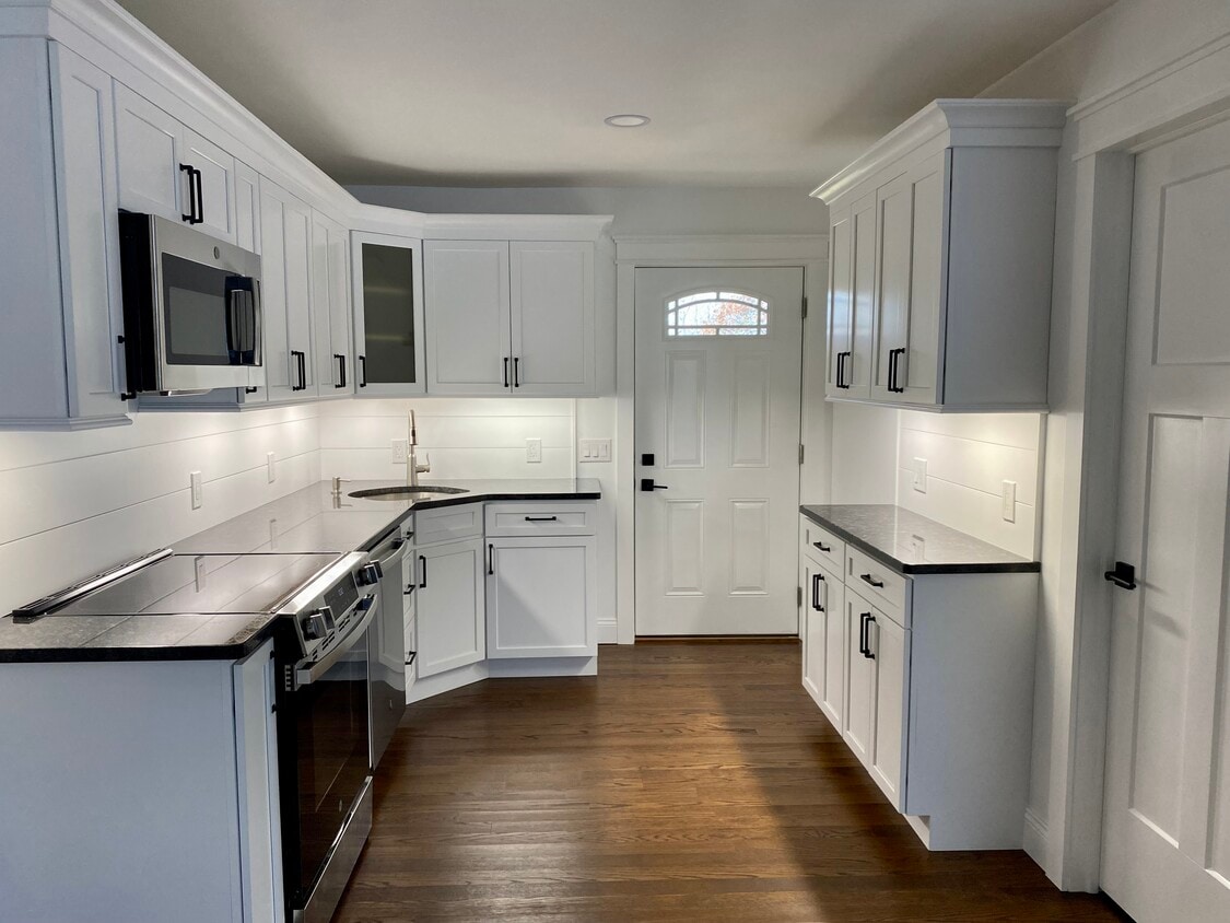 Kitchen with under cabinet lighting and dimmers. Wall mounted coat rack on wall by entrance. - 22 Denmore Ln