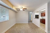 Located at 1108 Kennebec St in Oxon Hill, Maryland, this single-floor, 2-bedroom, 1-bathroom home offers a practical and well-organized layout. The combined living and dining area serves as the heart of the home, featuring warm neutral-toned carpeting, a ceiling fan with light fixture, and natural light from a large window. A pass-through opening connects this space directly to the kitchen, enhancing the open flow between rooms. The kitchen is outfitted with rich dark wood cabinetry, granite-style countertops, a white subway tile backsplash, wood-look flooring, and black appliances including a gas range, refrigerator, and dishwasher. Both bedrooms are carpeted and bright, with windows overlooking the outdoors and ample wall space. The spacious primary bedroom includes a ceiling fan, while both bedrooms benefit from closet storage with louvered bifold doors. A hallway connects the private areas of the home, leading to the full bathroom, which features large-format stone-look tile surrounding the soaking tub and a dark vanity with a white countertop. A utility room and additional closet provide practical storage solutions throughout the home.