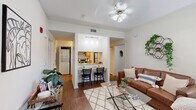 Located at 415 Chapel Dr in Tallahassee, FL, this 2-bedroom, 1-bathroom unit offers a thoughtfully arranged single-floor layout. The open-concept living room features warm wood-look flooring, a ceiling fan, and a large window that fills the space with natural light and outdoor views. It flows seamlessly into the kitchen, which is framed by a raised breakfast bar with seating for two — ideal for casual dining. The kitchen is equipped with stainless steel appliances, including a range, refrigerator, dishwasher, and built-in microwave, all complemented by light wood cabinetry and neutral countertops. A hallway connects the main living areas to the bedrooms and bathroom. The spacious primary bedroom features plush carpeting, a ceiling fan, a generous closet with bifold doors, and a window that allows ample natural light. The second bedroom is equally well-lit with carpeted floors, a ceiling fan, and its own window. The shared bathroom includes a large vanity with an integrated sink, wood-tone cabinetry, and tile flooring. Throughout, the unit maintains a clean, neutral color palette with white walls that create a bright and cohesive atmosphere.
