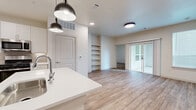 Located at 624 N Lancaster Ave in Dallas, TX, this well-appointed 2-bedroom, 3-bathroom single-story home offers a thoughtfully designed open-concept layout with modern finishes throughout. Light wood-look flooring flows seamlessly across the entire home, creating a cohesive and inviting aesthetic.

The kitchen serves as the heart of the home, featuring crisp white shaker cabinetry, quartz countertops, a neutral tile backsplash, stainless steel appliances including a gas range, microwave, and refrigerator, and a central island with pendant lighting overhead. The kitchen opens directly into the living area, which includes built-in open shelving and sliding glass doors that connect to a private outdoor space.

The primary bedroom is generously sized and provides direct access to a dedicated walk-in closet with built-in shelving and a well-appointed en-suite bathroom. The bathrooms are finished with white vanity cabinetry, illuminated mirrors, and wood-look flooring. The second bedroom also benefits from natural light through multiple windows and closet access.

Additional highlights include a walk-in closet with custom built-in organization in the primary suite, recessed and flush-mount lighting throughout, and a clean, neutral color palette that enhances the sense of openness across the entire floor plan.
