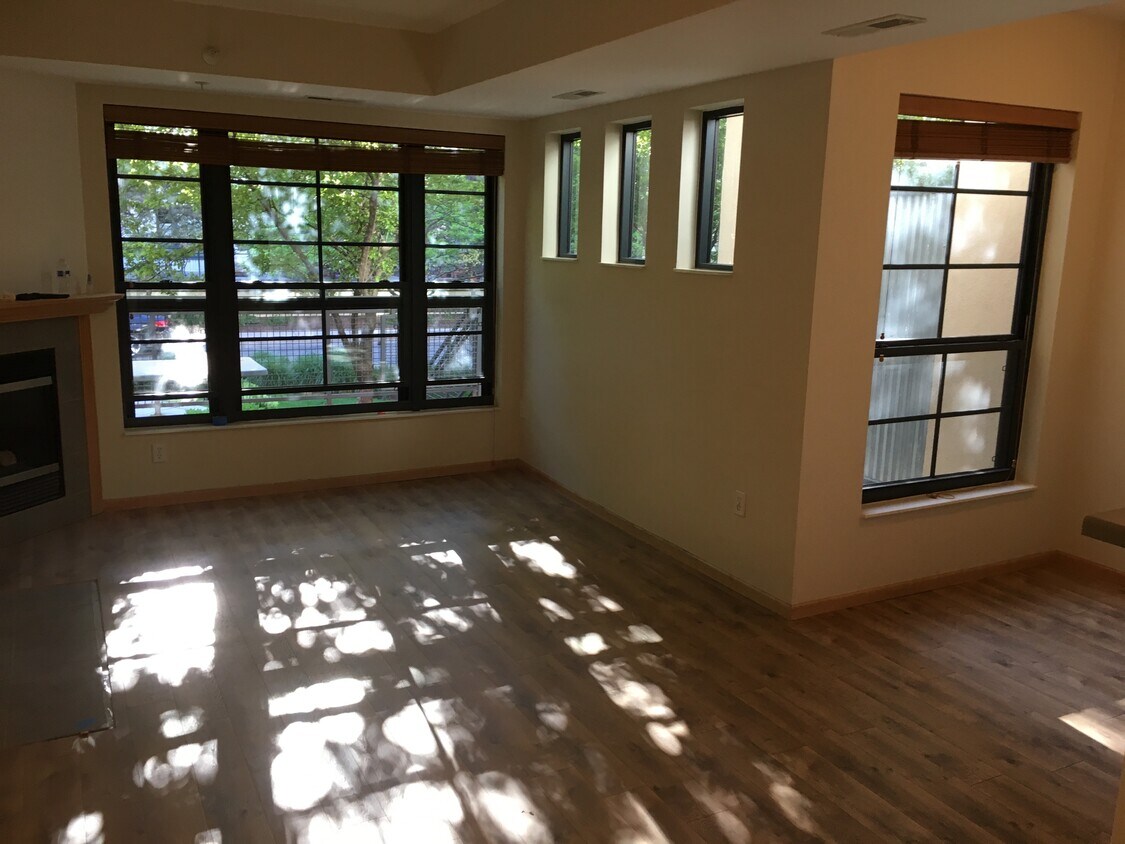 Living room flows from the kitchen and dining areas in a very functional open floor plan. - 825 Berry St