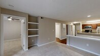 Located at 8720 Knickerbocker Way in Indianapolis, IN, this one-bedroom, one-bathroom residence offers a thoughtfully designed single-floor layout that maximizes functionality and comfort. The open-concept living and dining area features warm hardwood-style flooring, neutral toned walls, and built-in shelving that adds both character and practical storage. A sliding glass door at the end of the living area invites natural light and provides access to an outdoor balcony area.

The kitchen is a standout feature, equipped with rich dark cabinetry, granite countertops, stainless steel appliances including a refrigerator, microwave, and range, as well as a dishwasher. A peninsula with a granite overhang and built-in sink connects the kitchen to the main living space, making it ideal for both cooking and entertaining.

The bedroom is a comfortable retreat with plush carpet flooring, a ceiling fan, and a window overlooking a lush outdoor setting. A closet with panel doors provides ample storage. The bathroom offers hardwood-style flooring, a dark wood vanity with a white countertop, and clean, neutral finishes throughout. The overall ambiance is warm, modern, and move-in ready.