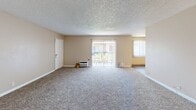 Located at 16818 Downey Ave in Paramount, CA, this single-floor, 2-bedroom, 2-bathroom home offers a well-organized layout across a comfortable footprint. The living area is bright and open, featuring plush carpeting, a classic fireplace with a decorative mantel, a textured ceiling, and a sliding glass door that leads to a private balcony, allowing natural light to fill the space. A large window with vertical blinds adds additional brightness to the adjoining area.

The kitchen is efficiently designed with white cabinetry, light countertops, wood-look flooring, and stainless steel appliances including a gas range and microwave. A skylight-style ceiling fixture enhances the workspace with overhead illumination.

Both bedrooms are carpeted and feature ceiling fans with lighting, vertical blind-covered windows for natural light, and ample closet space. The primary bedroom includes a spacious sliding-door closet. An additional dedicated closet with built-in shelving provides extra storage.

The two bathrooms are clean and functional — one with a walk-in shower and over-toilet cabinetry, and the other with a full tub-shower combination. Warm, neutral tones carry throughout the home, creating a cohesive and inviting atmosphere.