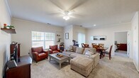 Located at 3548 Onyx Cir in Beavercreek, Ohio, this single-floor, one-bedroom, one-bathroom unit offers a practical and comfortable layout. The open-concept living and dining area is the heart of the home, featuring crown molding, a ceiling fan with light fixture, and soft carpeting throughout. Multiple windows allow natural light to fill the space, creating a bright and welcoming atmosphere. The living area provides ample room for seating, while the adjacent dining space accommodates a full-sized table — ideal for everyday meals or entertaining. A galley-style kitchen runs parallel to the main living space and is equipped with light wood cabinetry, tile flooring, a range, dishwasher, and built-in microwave, providing efficient use of space. The bedroom offers a comfortable, carpeted retreat with room for a queen-sized bed and additional furniture, along with closet access. The bathroom features tile flooring, a single vanity with a large mirror, and a shower/tub combination. This unit combines functional design with a cozy, well-maintained interior, making it a practical home in a convenient Beavercreek location.