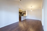 Located at 5501 Sherwood Dr in Midland, Texas, this single-story home offers a thoughtfully designed open-concept layout that seamlessly connects the main living areas. The living room is anchored by striking vaulted ceilings that lend an airy, expansive feel to the space, complemented by rich hardwood flooring that flows throughout the common areas.

The kitchen is a standout feature, boasting dark espresso cabinetry, granite countertops, a tile backsplash, and a full suite of stainless steel appliances including a range, microwave, and refrigerator. A peninsula with seating and pendant lighting bridges the kitchen and living area, making it ideal for both everyday living and entertaining. Built-in shelving near the entryway adds practical storage with a clean, architectural touch.

The bedrooms are carpeted for comfort and feature ceiling fans and windows that invite natural light. One room includes a glass-panel exterior door, providing direct outdoor access. The bathrooms are finished with granite-topped dark wood vanities, subway tile surrounds in the tub and shower areas, and tile flooring, offering a cohesive and polished aesthetic throughout the home.
