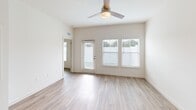 Located at 9000 Little Palm Way in Venice, FL, this thoughtfully designed single-story home offers a bright, modern interior with a clean, neutral palette throughout. The open-concept living and dining area is filled with natural light from multiple windows fitted with sleek blinds, and is complemented by light wood-look flooring and a ceiling fan. The well-appointed kitchen is a standout feature, showcasing white shaker cabinetry, quartz countertops, a gray subway tile backsplash, a stainless steel undermount sink, and a full suite of stainless steel appliances including a refrigerator with ice maker, electric range, built-in microwave, and dishwasher. A large island provides additional prep and dining space. The spacious bedroom benefits from abundant natural light through large windows, warm wood-look flooring, a ceiling fan, and access to a dedicated walk-in closet. The full bathroom features a white vanity with quartz countertop, a large mirror, and a glass-enclosed tiled shower. A separate laundry room houses a full-size washer and dryer. Outside, the property includes a generously sized, fully fenced backyard with vibrant artificial turf, offering a private and low-maintenance outdoor retreat.