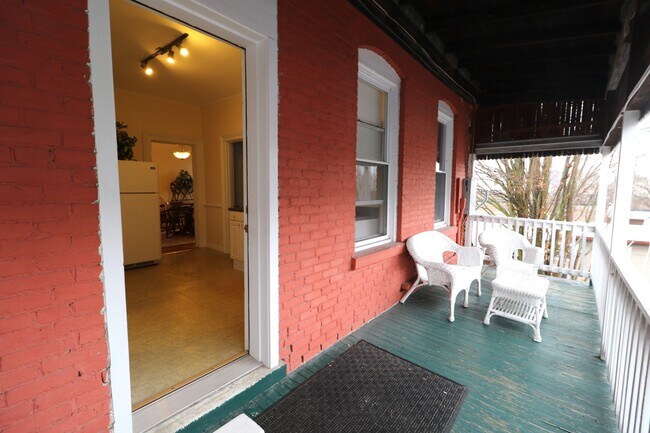 Porch with furniture, second entrance/fire escape. - 13 Main St