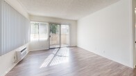Located in Brea, CA, this two-bedroom, one-bathroom residence offers a thoughtfully laid-out single-floor plan with a clean, neutral palette throughout. The living room is bright and open, featuring wood-style laminate flooring, a textured ceiling, and large windows with vertical blinds that invite generous natural light. Sliding glass doors lead to a private balcony, further enhancing the airy feel of the main living area. A dedicated dining area flows seamlessly from the living room, creating a practical and connected space.

The kitchen is efficiently designed with ample white cabinetry, light stone-style countertops, a double stainless steel sink, and a white electric range, all complemented by wood-style flooring and a drop ceiling with panel lighting.

Both bedrooms are carpeted for comfort. The spacious primary bedroom features a ceiling fan with light fixture, mirrored sliding closet doors that amplify the sense of space, and a window with vertical blinds. The second bedroom is cozy and well-lit with its own carpet flooring.

The bathroom includes a full tub-shower combination, a white vanity with stone-style countertop, a large mirror, and wood-style flooring. Two closets and a hallway complete this well-organized residence.