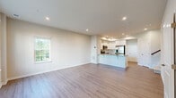 Located in Ellicott City, MD, this well-appointed two-story home offers three bedrooms, two bathrooms, and a thoughtfully designed layout spread across two floors. The main level features an open-concept living and kitchen area bathed in natural light from large windows with views of surrounding greenery. The kitchen is outfitted with crisp white cabinetry, granite-style countertops, a peninsula island, and a full suite of stainless steel appliances including a refrigerator, range, and built-in microwave. Light wood-style flooring flows throughout the main level, adding warmth and continuity to the space. A convenient half bathroom with hardwood-style flooring is also located on this floor. Upstairs, the generously sized primary bedroom offers plush carpeting, multiple windows with outdoor views, and access to a walk-in closet with built-in wire shelving. Two additional carpeted bedrooms provide ample natural light. The full bathroom features large-format tile surround with a soaking tub and shower combination. A dedicated laundry room with a stacked washer and dryer unit adds everyday convenience. Neutral tones and recessed lighting throughout create a clean, modern ambiance.