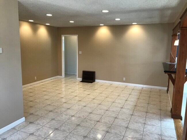 Spacious original living room with tiled floor, recessed lighting, and refurbished original 1952 Hol - 14911 Fonthill Ave
