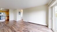 Located at 170 Parker Hill Ave in Boston's Mission Hill neighborhood, this two-bedroom, one-bathroom residence offers a practical and comfortable single-floor layout. Hardwood-style flooring flows consistently throughout the home, lending a cohesive and clean aesthetic to every room. The open kitchen and living area form the heart of the space, with the kitchen outfitted with light maple cabinetry, granite-style countertops, and a full suite of stainless steel appliances including a refrigerator, electric range, built-in microwave, and dishwasher. The living room is bright and airy, featuring sliding glass doors that open onto a private balcony, inviting natural light and outdoor access. Both bedrooms are well-proportioned with neutral walls and large windows that frame views of the Boston skyline and surrounding greenery. The primary bedroom includes a full-width closet with sliding doors, while the second bedroom features its own closet for ample storage. The bathroom is finished with beige ceramic tile surrounding a full soaking tub, accented by a decorative mosaic tile border, paired with a vanity and mirrored medicine cabinet. Baseboard heating is present throughout, ensuring year-round comfort in this thoughtfully laid-out Boston residence.
