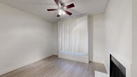 Located at 2343 W Main St in Mesa, AZ, this single-floor, 2-bedroom, 3-bathroom unit offers a clean and functional layout designed for comfortable everyday living. The open living room serves as the heart of the home, featuring a wood-look luxury vinyl plank floor, a ceiling fan with light fixture, and a classic fireplace framed in white — a standout focal point complemented by a large window with vertical blinds that allows ample natural light. The galley-style kitchen is efficiently designed with white cabinetry, light quartz countertops, a stainless steel sink, and a full suite of black appliances, including a refrigerator, range, microwave, and dishwasher. Both bedrooms offer plush carpeting, ceiling fans, and windows with vertical blinds. The primary bedroom includes a dedicated walk-in closet and its own bathroom access, while the second bedroom is serviced by the additional bathrooms. The bathrooms are finished in crisp white with a tub/shower combination and vanities featuring quartz-style countertops. A hallway connects the living areas to the bedrooms and includes a closet for additional storage. Textured ceilings and consistent white-toned walls throughout lend the space a bright, cohesive aesthetic.