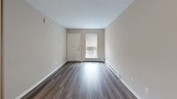 Located at 2609 Granite Hill Cir in Richmond, Virginia, this single-floor unit offers a thoughtfully updated interior with a clean, modern aesthetic. The open layout is anchored by durable wood-style flooring that runs throughout, complemented by neutral warm-toned walls and crisp white trim that together create a cohesive and inviting atmosphere.

The kitchen is a standout feature, showcasing white shaker-style cabinetry with brushed nickel hardware, a classic subway tile backsplash, and light quartz countertops. Stainless steel appliances — including a refrigerator, electric range, and range hood — complete the space, while a central island provides additional prep and counter space. The kitchen flows seamlessly into the main living area, which is bright and open with a window that invites natural light and includes baseboard heating for year-round comfort.

The bathroom is clean and functional, featuring a full-size soaking tub with an overhead shower, white tile surround, a white vanity, and wood-style flooring that mirrors the rest of the unit. Additional rooms offer versatile, open spaces with neutral walls and ample room for customization. The overall design emphasizes practicality and modern simplicity, making this a move-in ready space suited for a variety of needs.