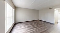 Located at 8610 Pine Tree Ct in Tampa, FL, this two-story home offers a practical and well-organized layout spread across two floors. The main level features a living room with wood-style laminate flooring, neutral gray walls, and a textured ceiling, creating a clean and versatile space. The galley-style kitchen is outfitted with white cabinetry, dark granite-look countertops, a double sink, and stainless steel appliances including a refrigerator and range, all complemented by light wood-style flooring and bright overhead lighting. A full bathroom on this level includes a tub-shower combo with chrome fixtures and white surround. Upstairs, the two bedrooms are carpeted and receive natural light through windows fitted with vertical blinds, offering pleasant outdoor views of the surrounding greenery. The spacious primary bedroom includes a double bifold closet with built-in shelving and hanging rods, providing ample storage. The second bedroom also features a bifold closet and a window with natural light. Both floors maintain a consistent, neutral color palette throughout, giving the home a cohesive and move-in-ready feel. A staircase connects the two levels, maintaining an efficient and functional flow throughout the residence.