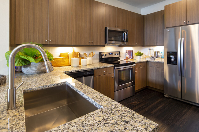 The gourmet kitchens feature stainless steel appliances and granite countertops - Windsor Shepherd