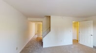 Located at 300 Cardinal Dr in Cincinnati, Ohio, this two-story residence offers a practical and comfortable layout spread across two levels. The main floor welcomes you with a bright living area featuring neutral carpet, a sliding glass door with vertical blinds that opens to outdoor views, and a dedicated staircase connecting to the upper level. The kitchen is well-appointed with light wood cabinetry, granite-style countertops, a double stainless steel sink, stainless steel refrigerator, and pendant lighting, complemented by hardwood flooring and a window that brings in natural light. A dedicated laundry area on the main floor includes overhead cabinetry, washer/dryer hookups, and an electrical panel, all finished with hardwood flooring. The upper level hosts multiple carpeted rooms, each featuring windows that allow generous natural light and views of the surrounding greenery. The full bathroom features hardwood flooring, a tiled tub and shower surround, a wood vanity, and clean, classic finishes. Throughout the home, neutral tones, plush carpeting in living spaces, and hardwood flooring in functional areas create a cohesive and move-in ready environment.