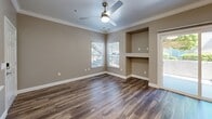 Located at 10270 E Taron Dr in Elk Grove, CA, this single-story residence offers a thoughtfully designed layout that maximizes comfort and functionality. The open-concept living room features warm hardwood-style flooring, crown molding, a ceiling fan, and a sliding glass door that floods the space with natural light while providing access to an outdoor patio area. A built-in niche adds a distinctive architectural touch to the living area.

The kitchen is well-equipped with crisp white shaker cabinetry, quartz countertops, a tile backsplash, and a full suite of stainless steel appliances, including a gas range, refrigerator, dishwasher, and microwave. A peninsula counter provides additional prep space and casual dining potential.

The bedroom is a comfortable retreat, featuring plush carpeting, a ceiling fan, and a window with outdoor views that bring in natural light. The full bathroom is finished with white cabinetry, quartz countertops, a large mirror, and a full tub-shower combination with clean white surround.

A dedicated laundry room includes an in-unit washer and dryer with overhead storage cabinetry, adding everyday convenience. Neutral tones and modern finishes throughout create a cohesive, move-in-ready atmosphere.