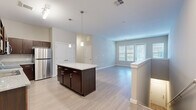 Located at 17880 E 64th Ave in Denver, CO, this thoughtfully designed 3-bedroom, 2-bathroom home delivers a comfortable and functional living experience across a well-utilized single floor. The open-concept kitchen and living area serves as the heart of the home, featuring light wood-look flooring, warm neutral tones, and an abundance of natural light streaming through white-blinded windows. The kitchen is well-appointed with rich dark-espresso cabinetry, granite-style countertops, a central island with pendant lighting, and a full suite of stainless steel appliances including a refrigerator, dishwasher, microwave, and range. The adjoining living room is spacious and bright, with an exterior door providing direct outdoor access. Three carpeted bedrooms offer comfortable retreats, including a generously sized primary bedroom with its own closet and private access to a bathroom. Additional closets throughout provide practical storage solutions. The two bathrooms are finished with wood-look flooring and include tub-shower combinations with clean white surrounds and chrome fixtures. A carpeted staircase with a wood handrail connects the levels of the home. The overall aesthetic is clean, modern, and move-in ready, making this Denver home an appealing and versatile space.