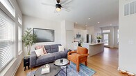 Located on Kenilworth Avenue in Norwood, Ohio, this contemporary multi-floor home offers a thoughtfully designed layout spread across three levels. The entry level provides a compact yet functional introduction to the space, while the main living floor serves as the heart of the home. Here, an open-concept kitchen and living room combine to create a bright, welcoming environment. The kitchen features crisp white shaker cabinetry, quartz countertops, stainless steel appliances, and a central island with a sink — ideal for both cooking and entertaining. The adjacent living area is filled with natural light from large windows and showcases warm hardwood-style flooring.

The upper floor houses the two bedrooms, including a spacious primary bedroom with multiple windows offering neighborhood views, plush carpeting, and a closet. The second bedroom is similarly well-appointed. A dedicated office on one of the upper levels provides a bright, focused workspace with natural light. Three bathrooms serve the home, including a full bath with a double-sink vanity, white quartz countertops, hardwood-style floors, and a glass-enclosed walk-in shower. A compact half bath is also conveniently tucked into the layout. Clean white walls, recessed lighting, and consistent modern finishes create a cohesive, airy aesthetic throughout.