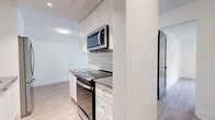 Located at 254 Gorge Rd E in Victoria, BC, this well-appointed one-bedroom, one-bathroom unit offers a thoughtfully designed single-level layout with modern finishes throughout. Light hardwood-style flooring runs continuously across the living spaces, creating a bright and cohesive feel.

The open living room is generously sized, bathed in natural light through a large sliding glass door that leads to an outdoor area with views of surrounding greenery. Baseboard heating runs along the perimeter, ensuring comfort year-round.

The galley-style kitchen is efficiently laid out and features white cabinetry with ample storage, a classic subway tile backsplash, dark countertops, recessed lighting, and a full suite of stainless steel appliances including a French door refrigerator, electric range, over-the-range microwave, and dishwasher.

The bedroom is a comfortable size, offering a window with garden views and a mirrored sliding closet that enhances the sense of space and light. The bathroom is finished with white subway tile walls, a neutral tile floor, an undermount sink with a grey vanity, and a glass-panel door, giving it a clean and contemporary look.

Overall, this unit presents a fresh, modern aesthetic with practical features throughout, ideal for comfortable urban living in Victoria.