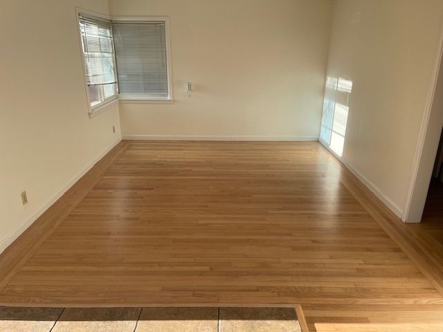 Newly refinished hardwood floor and new paint in living room. - 3729 46th St