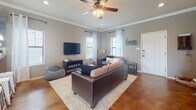Located at 3405 Treeline Dr in College Station, Texas, this two-story home blends functional design with warm, farmhouse-inspired character throughout its thoughtfully arranged layout. The heart of the home is a generously sized kitchen outfitted with gray shaker-style cabinetry, a subway tile backsplash, stained concrete floors, recessed lighting, and pendant fixtures over the peninsula. The adjacent dining area features stained concrete flooring and a bright window, with a staircase nearby connecting to the upper level. The living room offers crown molding, natural light from multiple windows dressed with sheer white curtains, and a welcoming atmosphere. Bedrooms are carpeted and well-lit, each featuring ceiling fans and ample natural light from large windows with blinds. One bedroom includes a private en-suite bathroom for added convenience. The bathrooms throughout the home feature tile flooring, single-sink vanities with understated cabinetry, large mirrors, and natural light. A dedicated laundry room houses a full-size washer and dryer with an overhead storage shelf. A spacious walk-in closet with dual hanging rods and built-in shelving provides excellent storage. The overall ambiance of the home is casual and inviting, with consistent warm-toned walls and practical finishes across all levels.