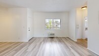 Located at 625-629 N Kenwood St in Glendale, CA, this one-bedroom, one-bathroom unit offers a practical and well-appointed single-floor layout. Light wood-style flooring flows throughout the entire space, creating a cohesive and bright aesthetic. The combined kitchen and living area serves as the heart of the home, anchored by a classic brick fireplace and elegant French doors that open to a balcony, flooding the space with natural light and providing outdoor views. The kitchen is well-equipped with white shaker cabinetry, stainless steel appliances including a gas range, microwave, dishwasher, and refrigerator, complemented by neutral countertops and a window above the sink. Additional cabinetry extends into the living area, offering generous built-in storage. The bedroom is comfortably sized, featuring a ceiling fan, a large sliding closet, and a window with natural light. A dedicated hallway closet provides further storage. The bathroom includes a full tub-shower combination with crisp white finishes and chrome fixtures. Textured ceilings are present throughout, adding subtle architectural character. Ceiling fans in both the living and bedroom areas contribute to year-round comfort in this clean, move-in-ready Glendale residence.