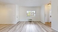 Located at 625-629 N Kenwood St in Glendale, CA, this one-bedroom, one-bathroom unit offers a practical and well-appointed single-floor layout. Light wood-style flooring flows throughout the entire space, creating a cohesive and bright aesthetic. The combined kitchen and living area serves as the heart of the home, anchored by a classic brick fireplace and elegant French doors that open to a balcony, flooding the space with natural light and providing outdoor views. The kitchen is well-equipped with white shaker cabinetry, stainless steel appliances including a gas range, microwave, dishwasher, and refrigerator, complemented by neutral countertops and a window above the sink. Additional cabinetry extends into the living area, offering generous built-in storage. The bedroom is comfortably sized, featuring a ceiling fan, a large sliding closet, and a window with natural light. A dedicated hallway closet provides further storage. The bathroom includes a full tub-shower combination with crisp white finishes and chrome fixtures. Textured ceilings are present throughout, adding subtle architectural character. Ceiling fans in both the living and bedroom areas contribute to year-round comfort in this clean, move-in-ready Glendale residence.
