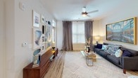 Located in Charlotte, NC, this single-story residence offers a thoughtfully designed open-concept layout that balances comfort and modern style throughout. The living area is bright and inviting, featuring large windows that allow natural light to pour in, ceiling fans, and plush carpeting underfoot — creating a warm, relaxed atmosphere ideal for both entertaining and everyday living.

The kitchen is a standout feature, showcasing crisp white shaker cabinetry extending to the ceiling, granite countertops, a classic subway tile backsplash, and a full suite of stainless steel appliances. Wood-look flooring and pendant lighting add a polished, contemporary touch, while the open flow to the living space makes the kitchen feel connected and functional.

The bedrooms are generously sized, each with plush carpet, ceiling fans, and large windows offering outdoor views. The primary bedroom connects to a well-appointed en-suite bathroom featuring granite countertops, white cabinetry, wood-look flooring, and a tub-shower combination. A spacious walk-in closet with wire shelving provides ample storage. A second bathroom mirrors the same refined finishes, including a granite vanity and a separate shower enclosure. The overall ambiance is clean, modern, and move-in ready.