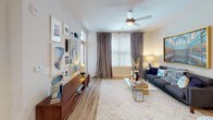 Located in Charlotte, NC, this single-story residence offers a thoughtfully designed open-concept layout that balances comfort and modern style throughout. The living area is bright and inviting, featuring large windows that allow natural light to pour in, ceiling fans, and plush carpeting underfoot — creating a warm, relaxed atmosphere ideal for both entertaining and everyday living.

The kitchen is a standout feature, showcasing crisp white shaker cabinetry extending to the ceiling, granite countertops, a classic subway tile backsplash, and a full suite of stainless steel appliances. Wood-look flooring and pendant lighting add a polished, contemporary touch, while the open flow to the living space makes the kitchen feel connected and functional.

The bedrooms are generously sized, each with plush carpet, ceiling fans, and large windows offering outdoor views. The primary bedroom connects to a well-appointed en-suite bathroom featuring granite countertops, white cabinetry, wood-look flooring, and a tub-shower combination. A spacious walk-in closet with wire shelving provides ample storage. A second bathroom mirrors the same refined finishes, including a granite vanity and a separate shower enclosure. The overall ambiance is clean, modern, and move-in ready.