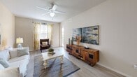 Located at 4590 Winkler Ave in Fort Myers, Florida, this single-floor residence offers a thoughtfully designed layout encompassing one bedroom, one bathroom, a living room, kitchen, hallway, and closet. The living room features light wood-style flooring, a ceiling fan, and large windows that invite natural light, creating a bright and airy atmosphere. Sliding glass doors lead to a private outdoor balcony, extending the living space and providing outdoor views. The kitchen is outfitted with dark espresso cabinetry, granite-style countertops, and black appliances including a refrigerator, range, and microwave, complemented by a skylight feature overhead that adds brightness to the space. The spacious bedroom offers plush carpeting, a ceiling fan, and a soft, neutral color palette accented by a light blue feature wall. A dedicated closet provides convenient storage. The bathroom includes a dark vanity with a large mirror, a tub/shower combination, and light wood-style flooring that ties cohesively to the rest of the residence. Throughout the home, warm neutral tones and consistent finishes create a harmonious and comfortable living environment well-suited to the sunny Fort Myers climate.
