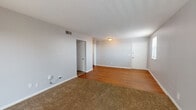 Located at 721 Due West Ave N in Nashville, Tennessee, this single-floor home offers a practical and comfortable layout throughout. The open living and dining area features a combination of warm hardwood flooring and plush carpeting, with neutral gray walls and overhead lighting that create a clean, versatile atmosphere. A ceiling vent indicates central air and heating throughout the space.

The kitchen is well-equipped with stainless steel appliances, including a refrigerator, electric range, and dishwasher. White cabinetry extends to the ceiling for ample storage, while dark granite-style countertops and a double-basin stainless steel sink add functionality. Hardwood flooring continues through the kitchen, connecting seamlessly with the main living areas.

Multiple bedrooms are finished with wall-to-wall carpeting and soft neutral paint, offering comfortable and quiet retreats. Several rooms feature windows that allow natural light to filter in. The bathroom includes a full tiled tub and shower combination, a vanity with dark countertop, white cabinetry, and tile flooring, providing a clean and efficient layout. The overall design of the home is straightforward and move-in ready, suited for practical everyday living in a convenient Nashville location.