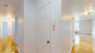 Located at 6001 Ch de la Côte-Saint-Luc in the desirable borough of Hampstead, Quebec, this well-maintained 2-bedroom, 1-bathroom unit is spread across a single floor. Gleaming hardwood floors run throughout the living areas and bedrooms, lending a warm and cohesive character to the space.

The spacious primary bedroom is a standout feature, offering generous proportions, a large window that frames views of mature trees, and a baseboard heating unit for year-round comfort. The second bedroom is equally well-lit, with its own window overlooking the greenery outside. Both rooms feature clean white walls and polished wood floors that reflect natural light throughout the day.

The kitchen is thoughtfully designed with rich warm-toned wood cabinetry, a mosaic tile backsplash, dark countertops, and stainless steel appliances including a full-size refrigerator and dishwasher. Tile flooring and a window above the sink add practicality and brightness to the space.

The bathroom is finished in crisp white tile and features a full bathtub with an overhead shower, a window for ventilation, and built-in shelving. A hallway connects the rooms, providing a functional flow throughout the unit. The overall ambiance is bright, clean, and comfortable.