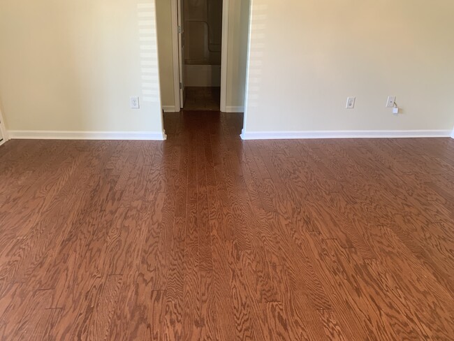 Living room looking into hallway that connects 2nd and 3rd bedroom with 2nd bathroom in between - 341 cypress dr