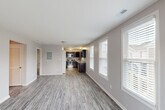 Located at 3534 Hiram St in Saint Charles, MO, this well-designed two-bedroom, two-bathroom single-story home offers a functional and comfortable layout. The open-concept living area flows seamlessly into the kitchen, featuring durable wood-look plank flooring, neutral gray walls, and multiple windows that allow ample natural light to fill the space. A glass-panel exterior door in the living room provides additional brightness and outdoor views.

The kitchen is a standout feature, equipped with dark espresso cabinetry, granite countertops, a stainless steel refrigerator, range, and microwave, along with a double basin sink — providing both style and practicality for everyday cooking.

Both bedrooms are carpeted and include ceiling fans with light fixtures, generous closet space with paneled sliding doors, and windows that bring in natural light. The spacious primary bedroom offers a comfortable retreat with room for substantial furnishings.

The two bathrooms are clean and efficiently designed, each featuring a full tub-shower combination with chrome fixtures, a vanity with dark cabinetry, and wood-look tile flooring. A hallway connects the main living spaces to the bedrooms and bathrooms, completing the efficient single-floor layout.