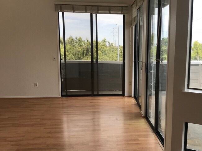 Living room with 3 sliders for lots of light - 22330 Homestead Rd